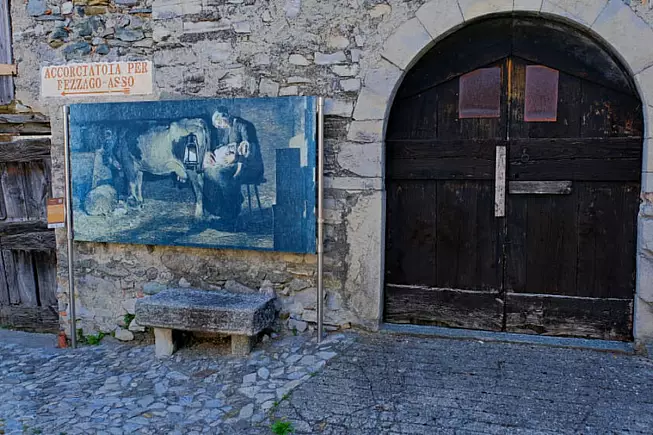  Il borgo di Caglio con la riproduzione di un'opera di Giovanni Segantini