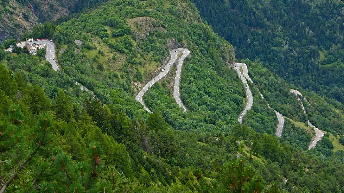 Alpe d'Huez. Vista dei tornanti e della Église Saint-Ferréol. iStock-537525106